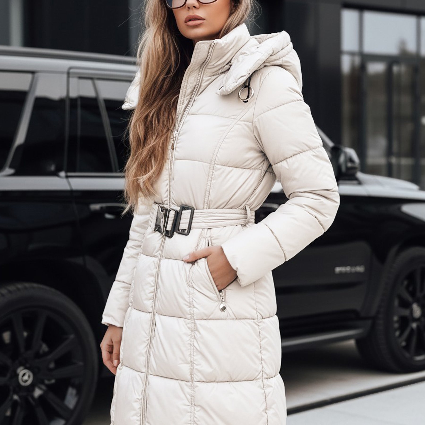 Image of Women's Long Quilted Jacket With A Detachable Hood And Waistband, Knee-length Women's Jacket With A Zipper And Zippered Pockets, Polyester, , Quilted Women's Outerwear.